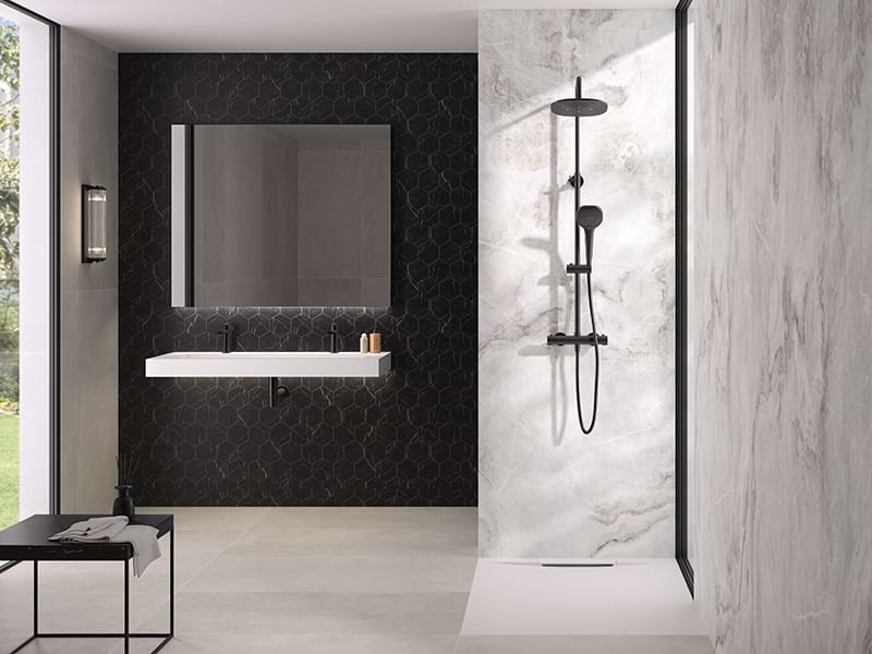 Kinedo luxury alabaster marble bathroom panels with matte black shower system and hexagonal feature wall.