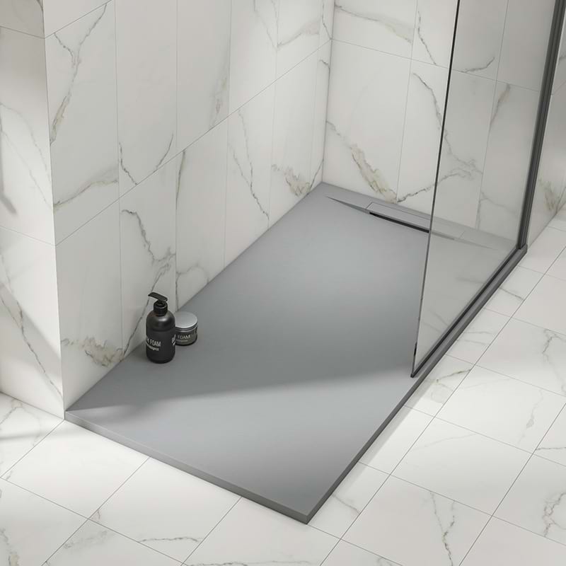 A rectangular Kineline shower tray in grey installed within a modern shower enclosure